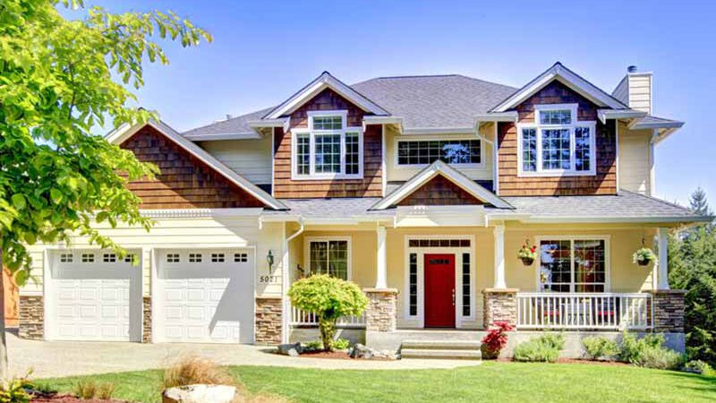 Two-story home with dormers and 2-car garage.